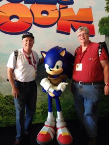 Tom Kalinske and Al Nilsen pose with Sonic the Hedgehog.